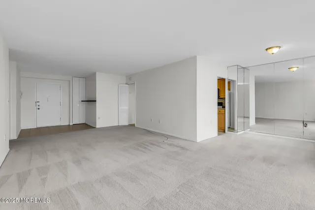 a view of an empty room with large windows