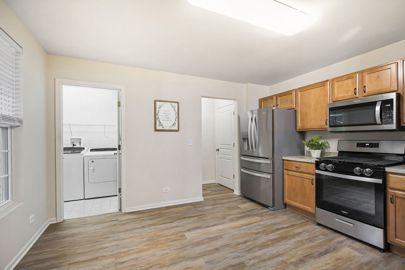 626 South Curran Road Round Lake, IL 60073 - Photo 12 of 25 a kitchen with a refrigerator stove and wooden floor