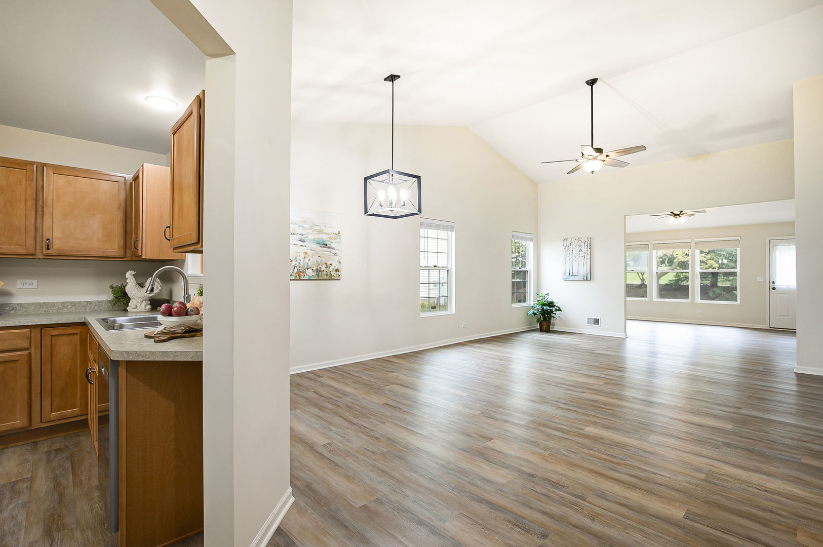 626 South Curran Road Round Lake, IL 60073 - Photo 14 of 25 a view of a kitchen with wooden floor and a window