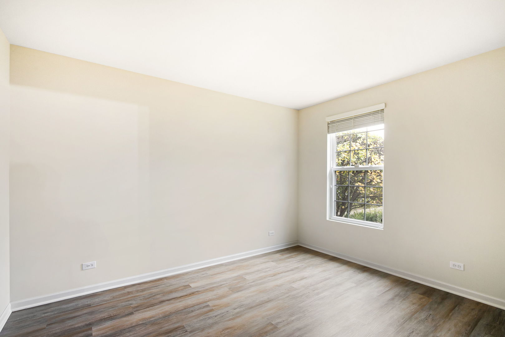 626 South Curran Road Round Lake, IL 60073 - Photo 20 of 25 an empty room with wooden floor and windows