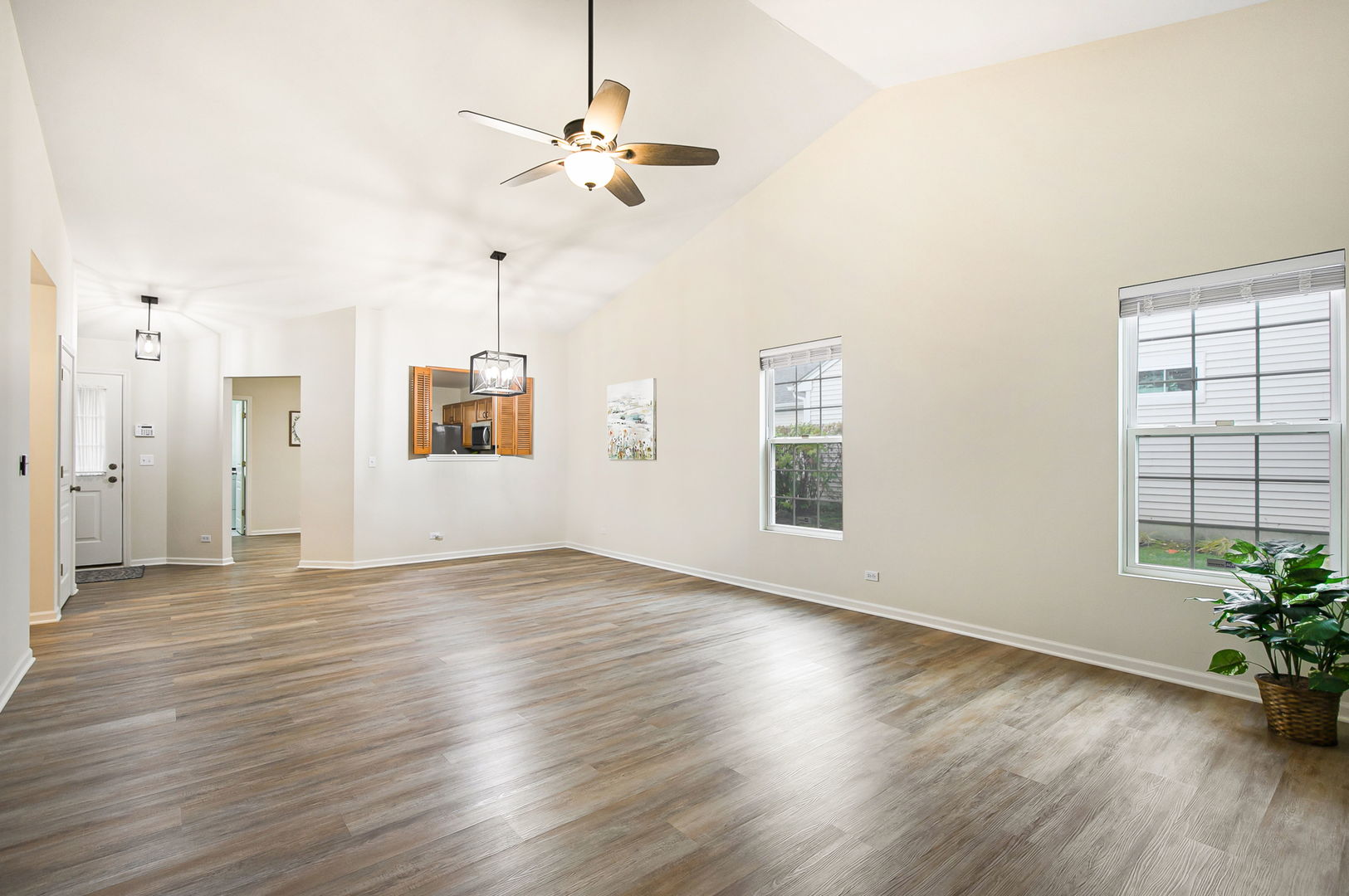 626 South Curran Road Round Lake, IL 60073 - Photo 7 of 25 an empty room with wooden floor and windows