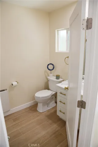 a bathroom with a toilet sink and a mirror