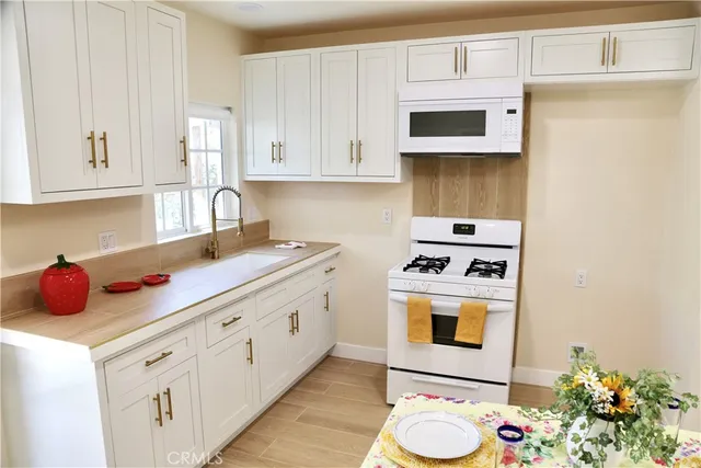 a kitchen with cabinets appliances and a sink