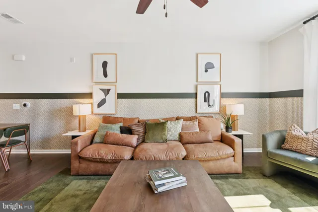 a living room with furniture kitchen view and a table