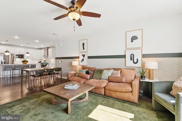 a living room with furniture a rug and a chandelier