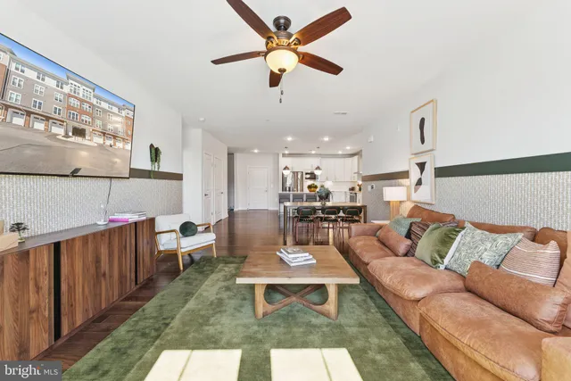 a bedroom with a bed mirror and couch