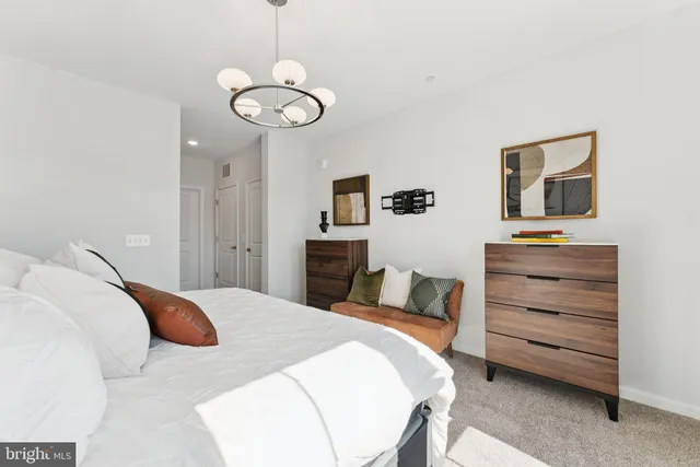 a bedroom with a bed and a chair