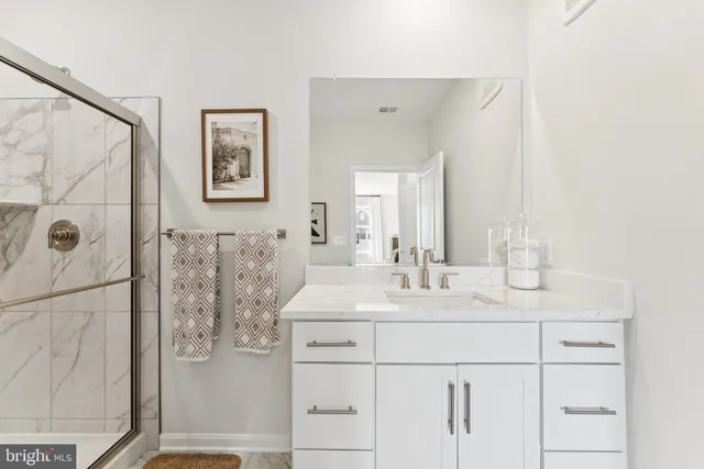 a bedroom with two beds and a chandelier