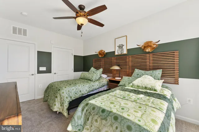 a bedroom with a bed dresser and a window