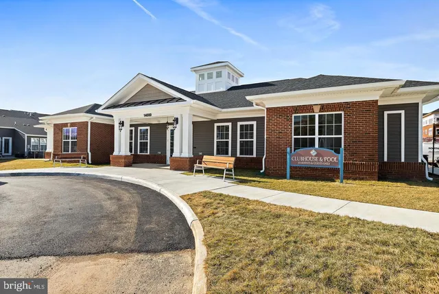 a living room with furniture a clock and a large window