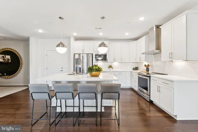 a kitchen that has a lot of cabinets a sink and appliances in it