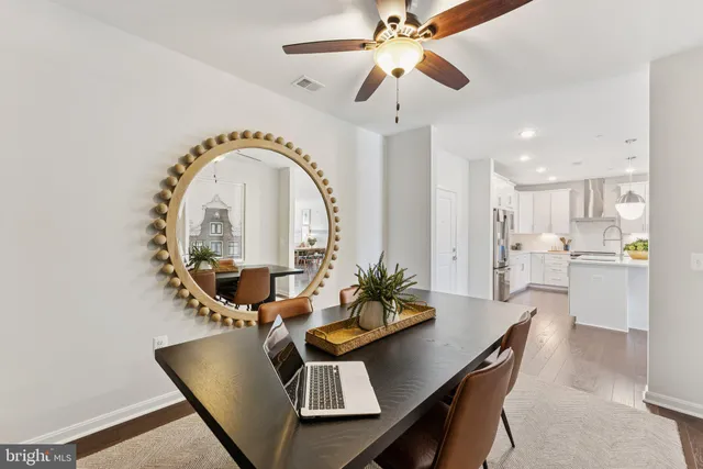 a living room with furniture dining table and wooden floor