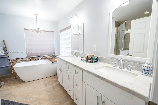 a spacious bathroom with a bathtub sink and a window