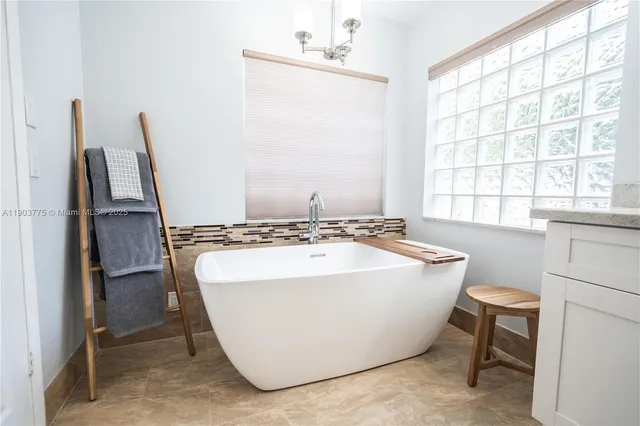a bathroom with a granite countertop sink a mirror and a shower