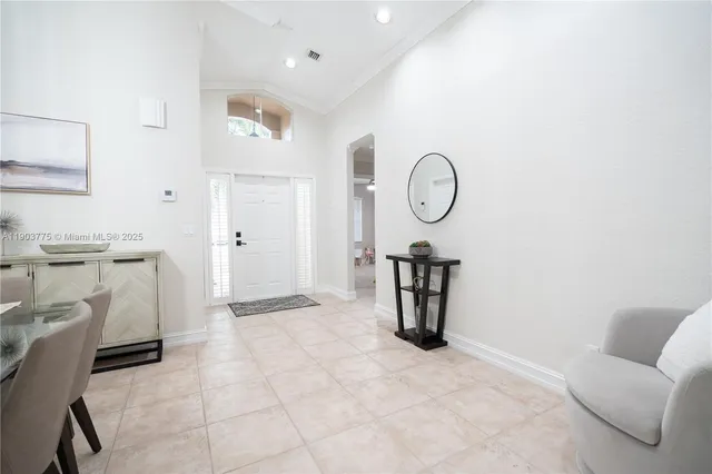 a living room with furniture a clock and white walls