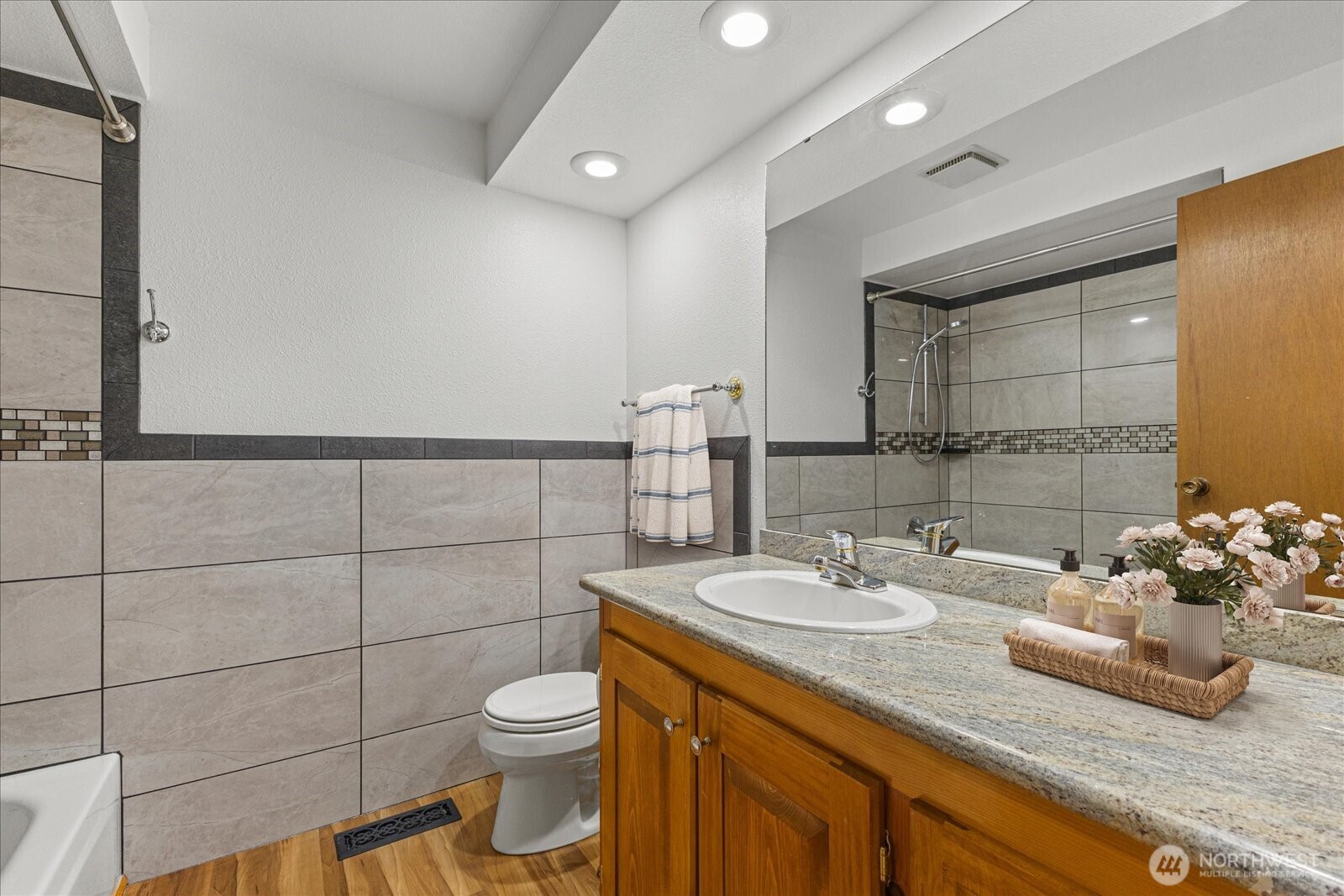 12121 Northeast 161st Street Bothell, WA 98011 - Photo 12 of 22 a bathroom with a granite countertop sink a toilet and a mirror