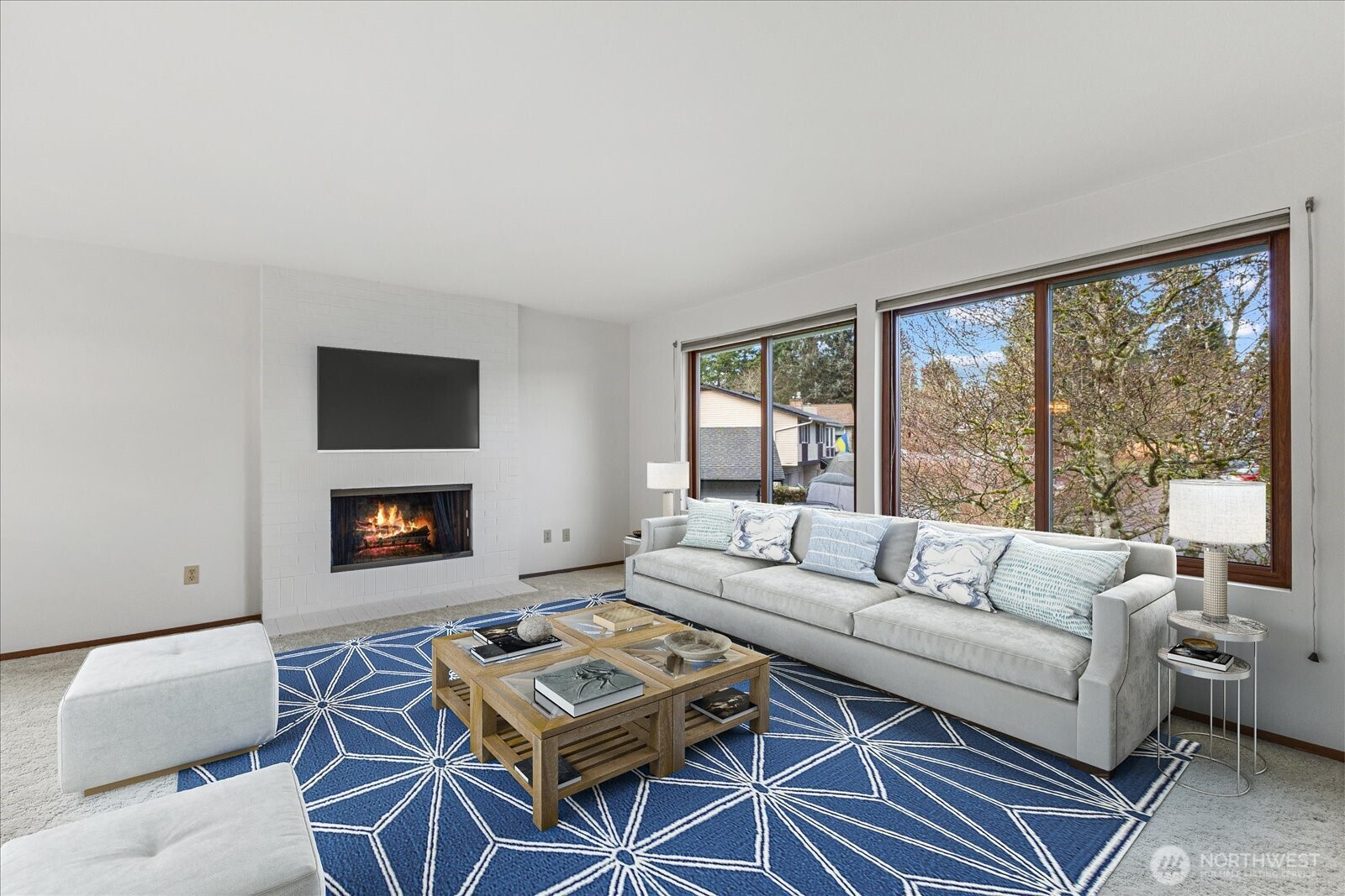 12121 Northeast 161st Street Bothell, WA 98011 - Photo 2 of 22 a living room with furniture a rug a flat screen tv and a large window