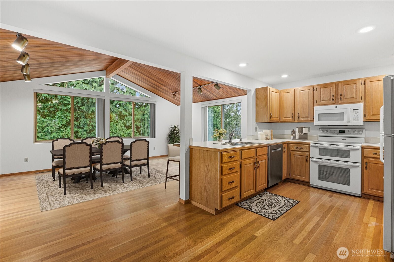 12121 Northeast 161st Street Bothell, WA 98011 - Photo 4 of 22 a kitchen with stainless steel appliances granite countertop sink stove top oven and cabinets