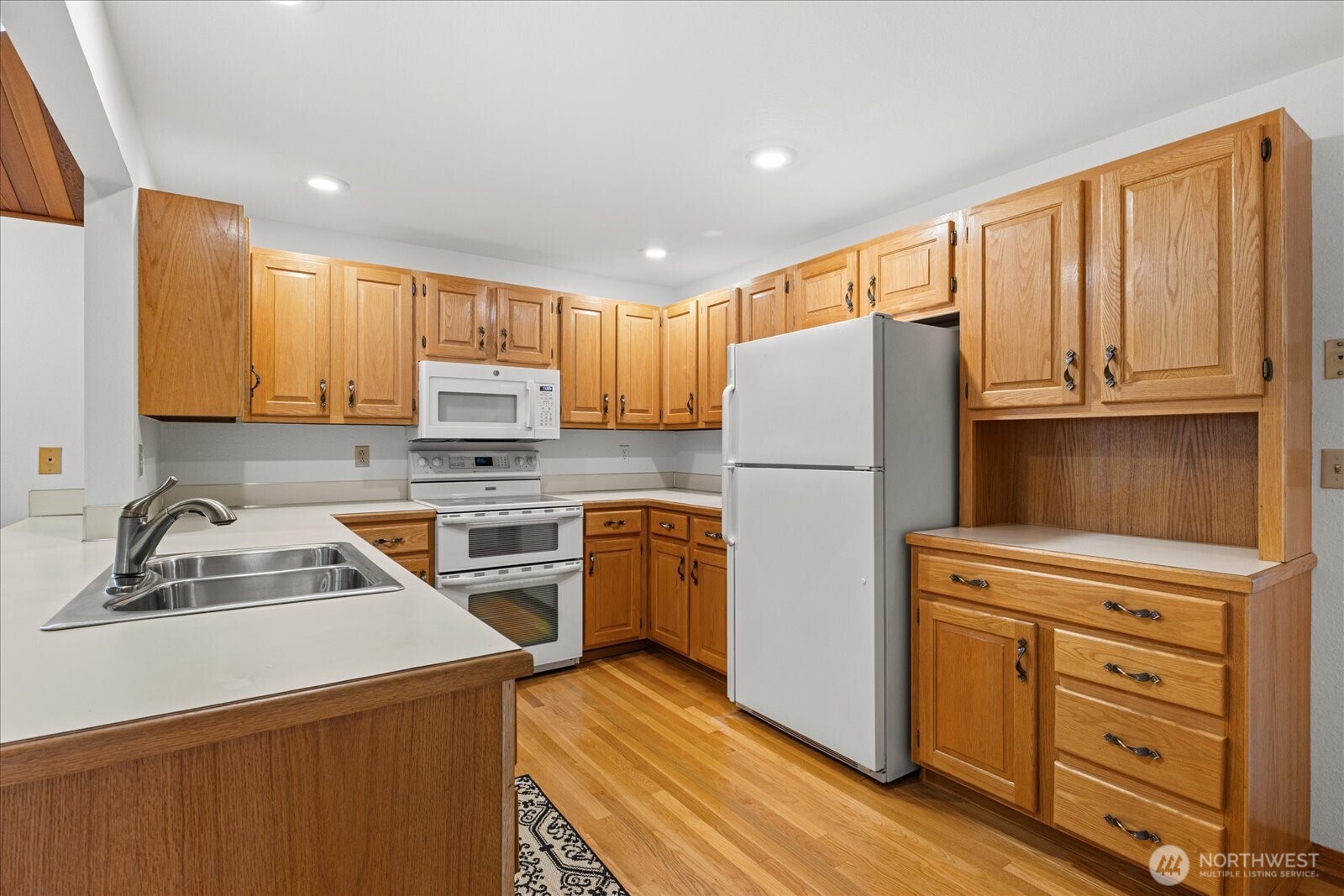 12121 Northeast 161st Street Bothell, WA 98011 - Photo 7 of 22 a kitchen with a refrigerator stove and microwave