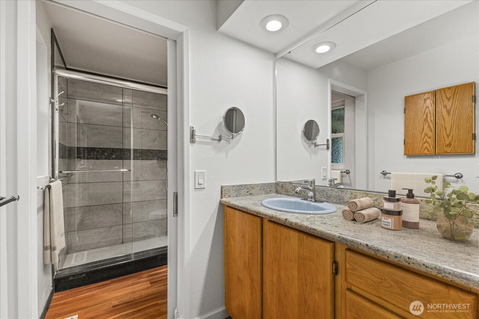 12121 Northeast 161st Street Bothell, WA 98011 - Photo 9 of 22 a bathroom with a granite countertop sink mirror and shower