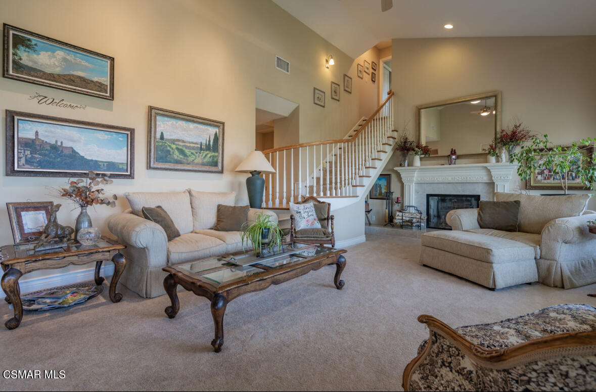 1029 Alta Vista Road Simi Valley, CA 93063 - Photo 7 of 20 a living room with furniture a fireplace and a chandelier