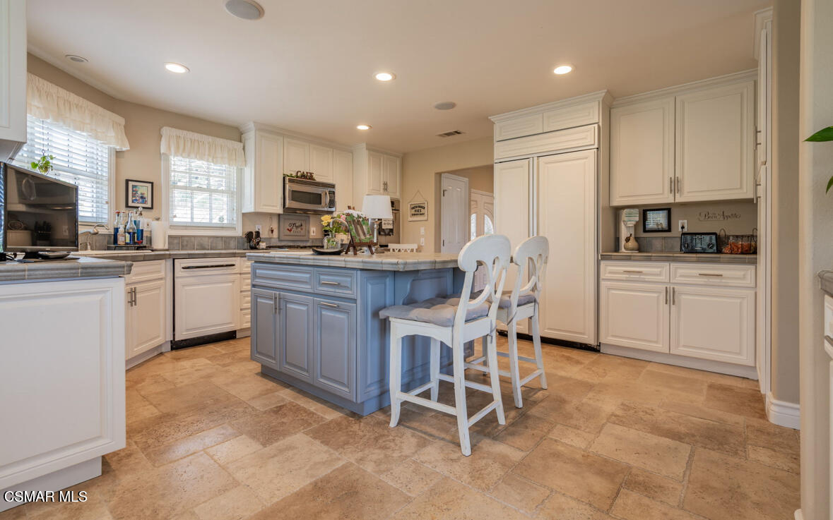 1029 Alta Vista Road Simi Valley, CA 93063 - Photo 8 of 20 a kitchen with a sink a stove a refrigerator and chairs