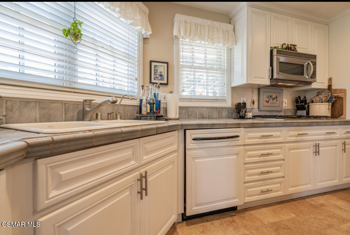 1029 Alta Vista Road Simi Valley, CA 93063 - Photo 10 of 20 a kitchen with granite countertop white cabinets stainless steel appliances a sink and a window