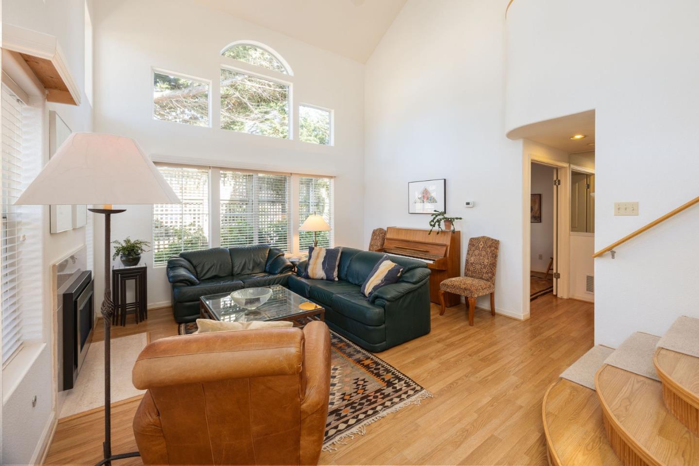 40 Patrick Way Half Moon Bay, CA 94019 - Photo 4 of 39 a living room with furniture a bed and a chandelier