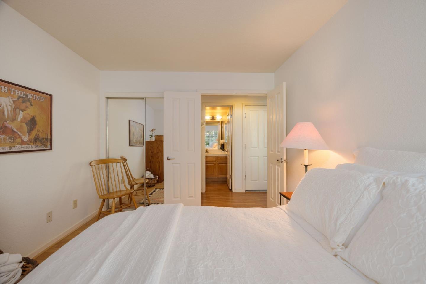 40 Patrick Way Half Moon Bay, CA 94019 - Photo 10 of 39 a bedroom with a bed and a chandelier
