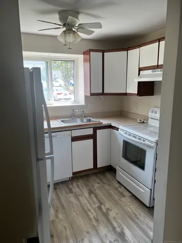 a kitchen with a stove sink and microwave
