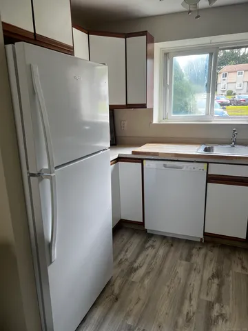 a white refrigerator freezer sitting inside of a kitchen