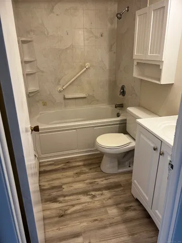 a bathroom with a toilet and a shower