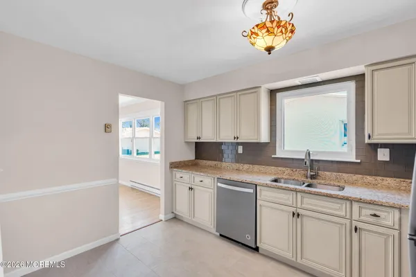 a kitchen with a sink cabinets and window