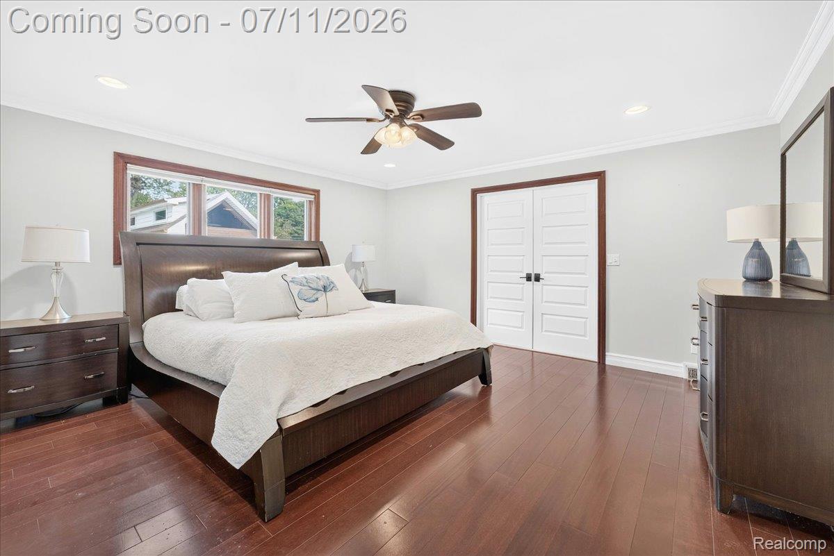 23750 East River Road Grosse Ile, MI 48138 - Photo 20 of 54 Spacious room featuring wood-finish flooring, white paneled double doors, recessed lighting, and a ceiling fan
