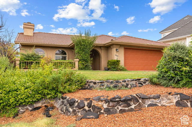 439 Paintbrush Way St. George, UT 84790 - Photo 1 of 1 Mediterranean / spanish-style house featuring stucco siding, a garage, a chimney, and a tiled roof