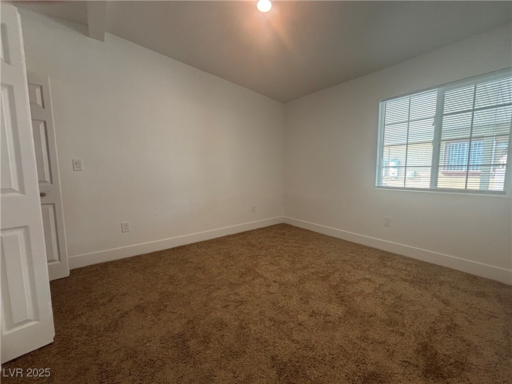 724 North 9th Street, Unit 2 Las Vegas, NV 89101 - Photo 6 of 10 Spare room with dark carpet and baseboards