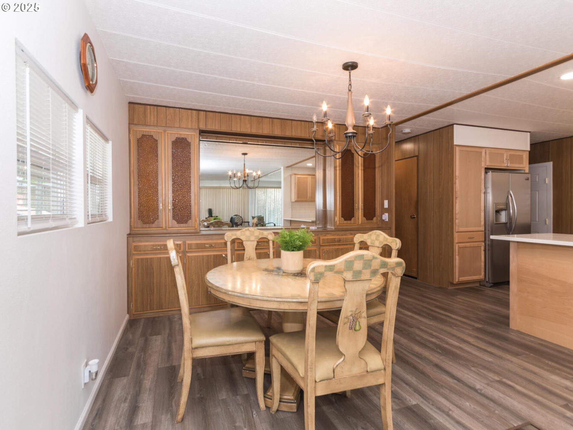 21016 Southeast Stark Street, Unit 69 Gresham, OR 97030 - Photo 18 of 43 a dining room with furniture a chandelier and wooden floor