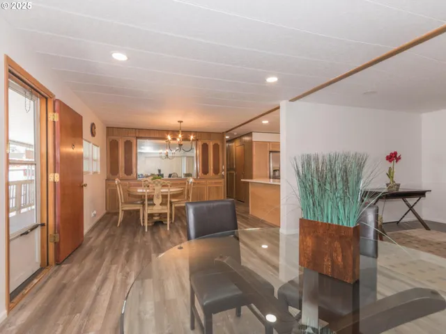 a dining room with furniture a chandelier and wooden floor
