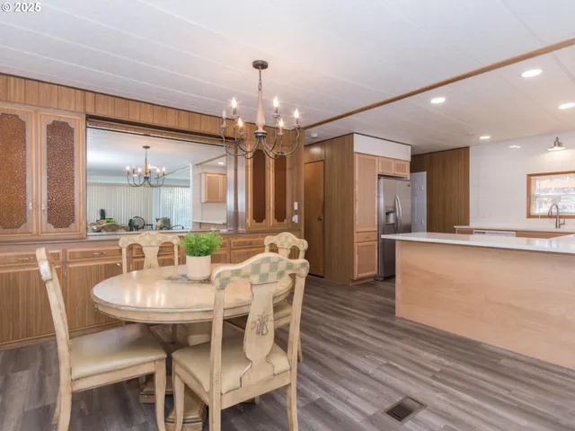 a kitchen with granite countertop a refrigerator and a sink