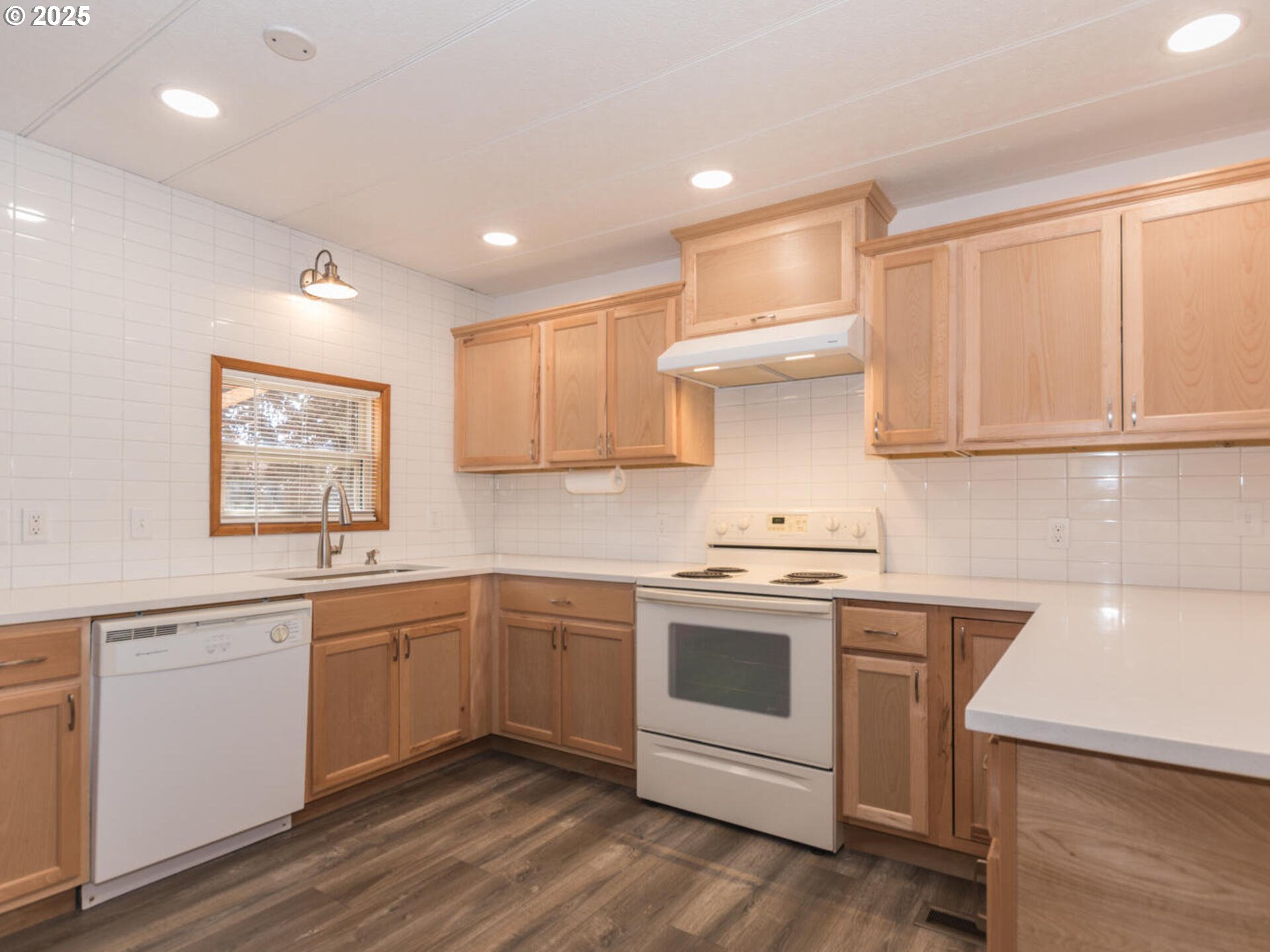 21016 Southeast Stark Street, Unit 69 Gresham, OR 97030 - Photo 22 of 43 a kitchen with a sink cabinets and wooden floor