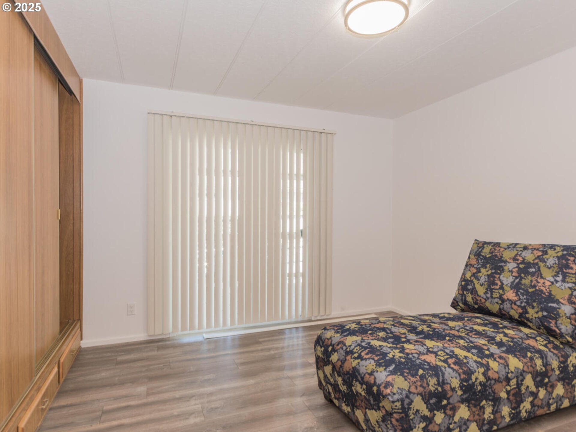 21016 Southeast Stark Street, Unit 69 Gresham, OR 97030 - Photo 29 of 43 a bedroom with a bed and wooden floor