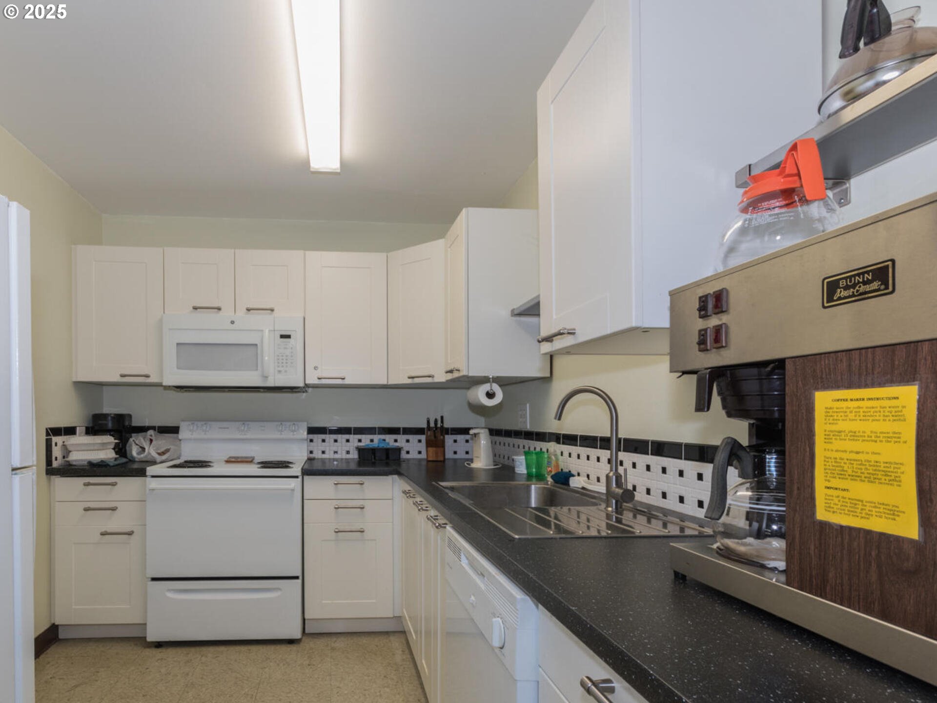21016 Southeast Stark Street, Unit 69 Gresham, OR 97030 - Photo 40 of 43 a kitchen with granite countertop a sink stove and cabinets