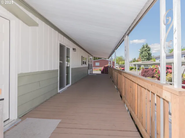 a view of a porch with wooden floor and furniture
