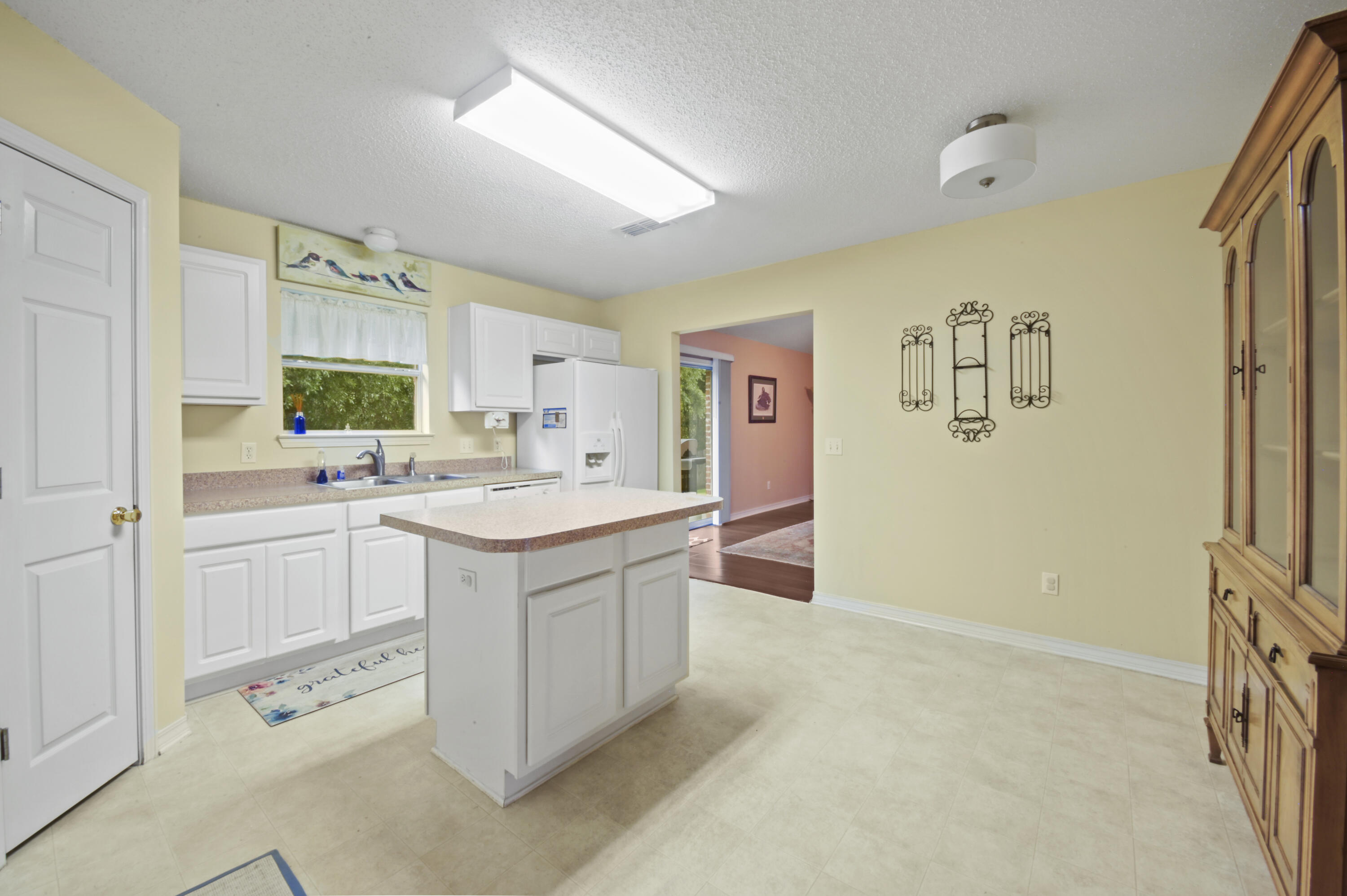 334 Egan Drive Crestview, FL 32536 - Photo 13 of 33 a kitchen with a sink cabinets and window