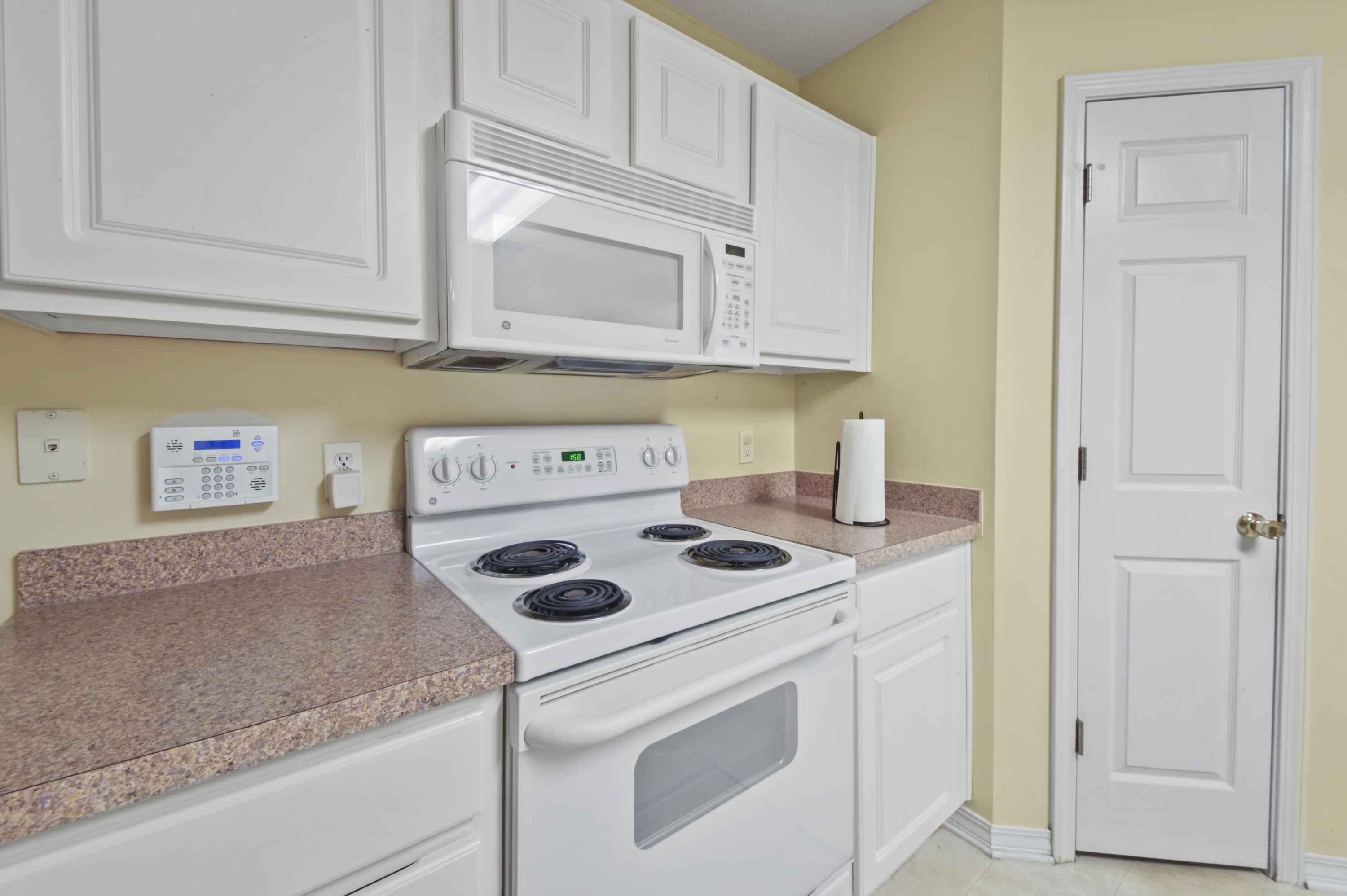 334 Egan Drive Crestview, FL 32536 - Photo 15 of 33 a kitchen with white cabinets and white appliances