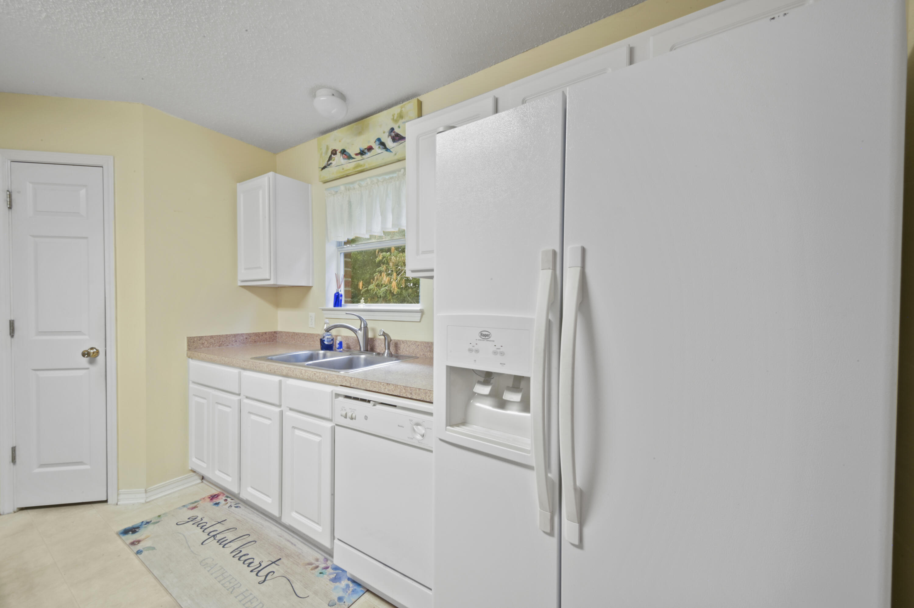 334 Egan Drive Crestview, FL 32536 - Photo 16 of 33 a kitchen with a sink cabinets and appliances
