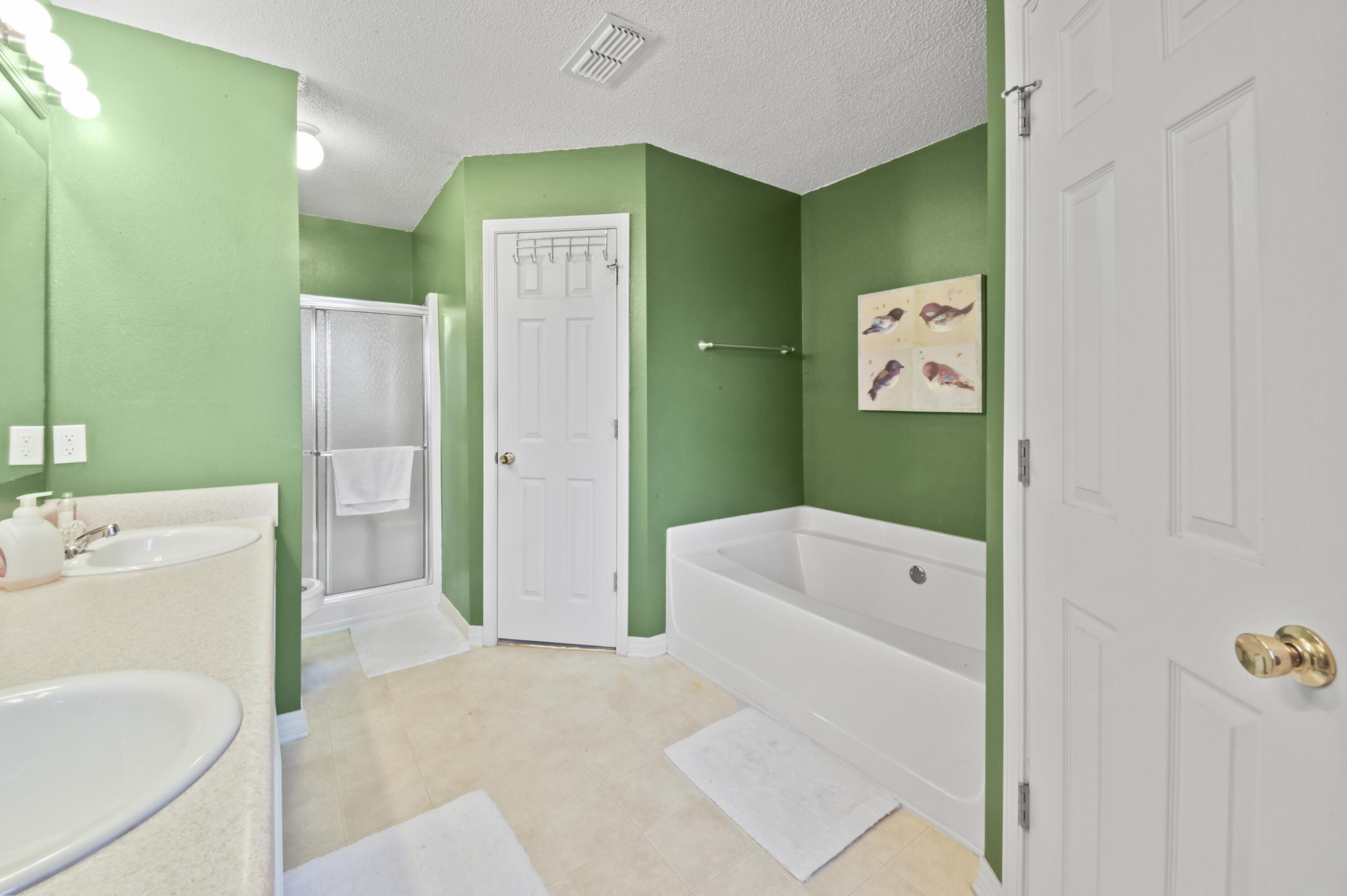 334 Egan Drive Crestview, FL 32536 - Photo 21 of 33 a bathroom with a tub a sink and a refrigerator