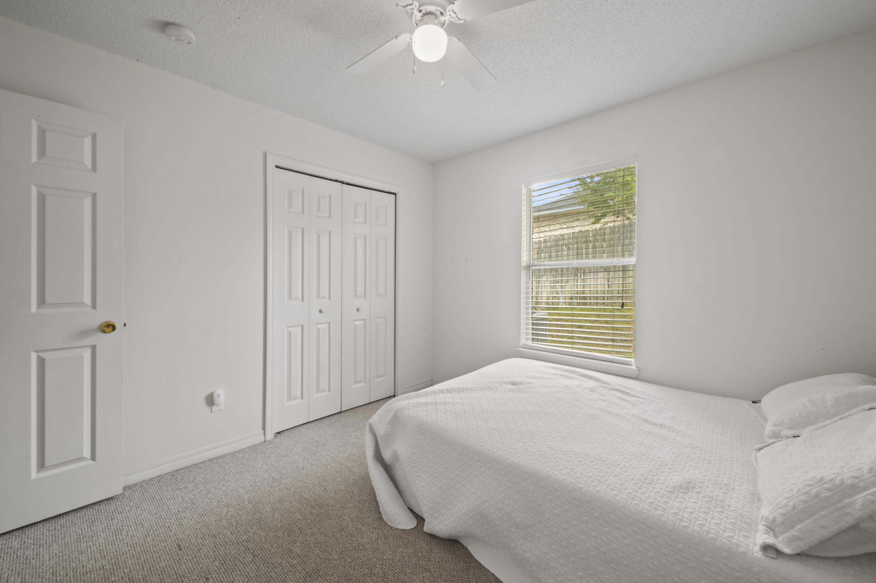 334 Egan Drive Crestview, FL 32536 - Photo 22 of 33 a bedroom with a bed and a chandelier