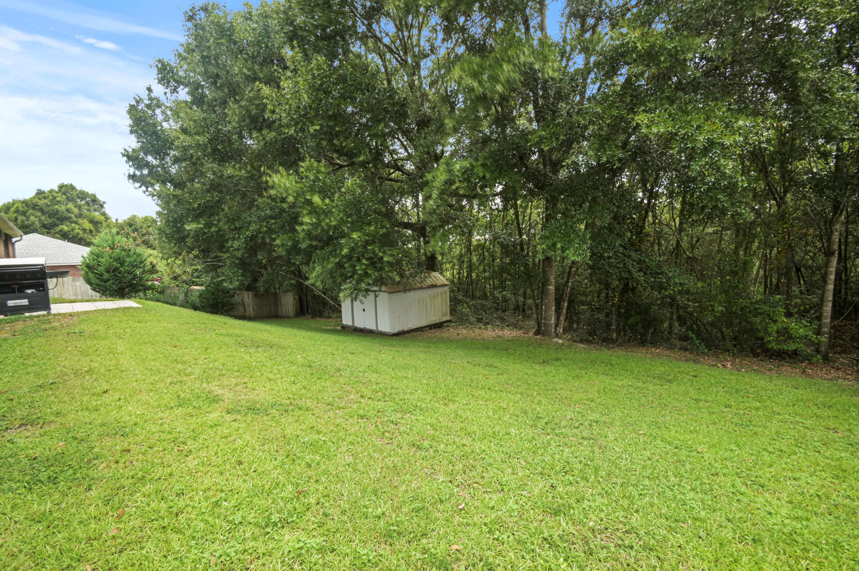 334 Egan Drive Crestview, FL 32536 - Photo 32 of 33 a backyard of a house with barbeque oven