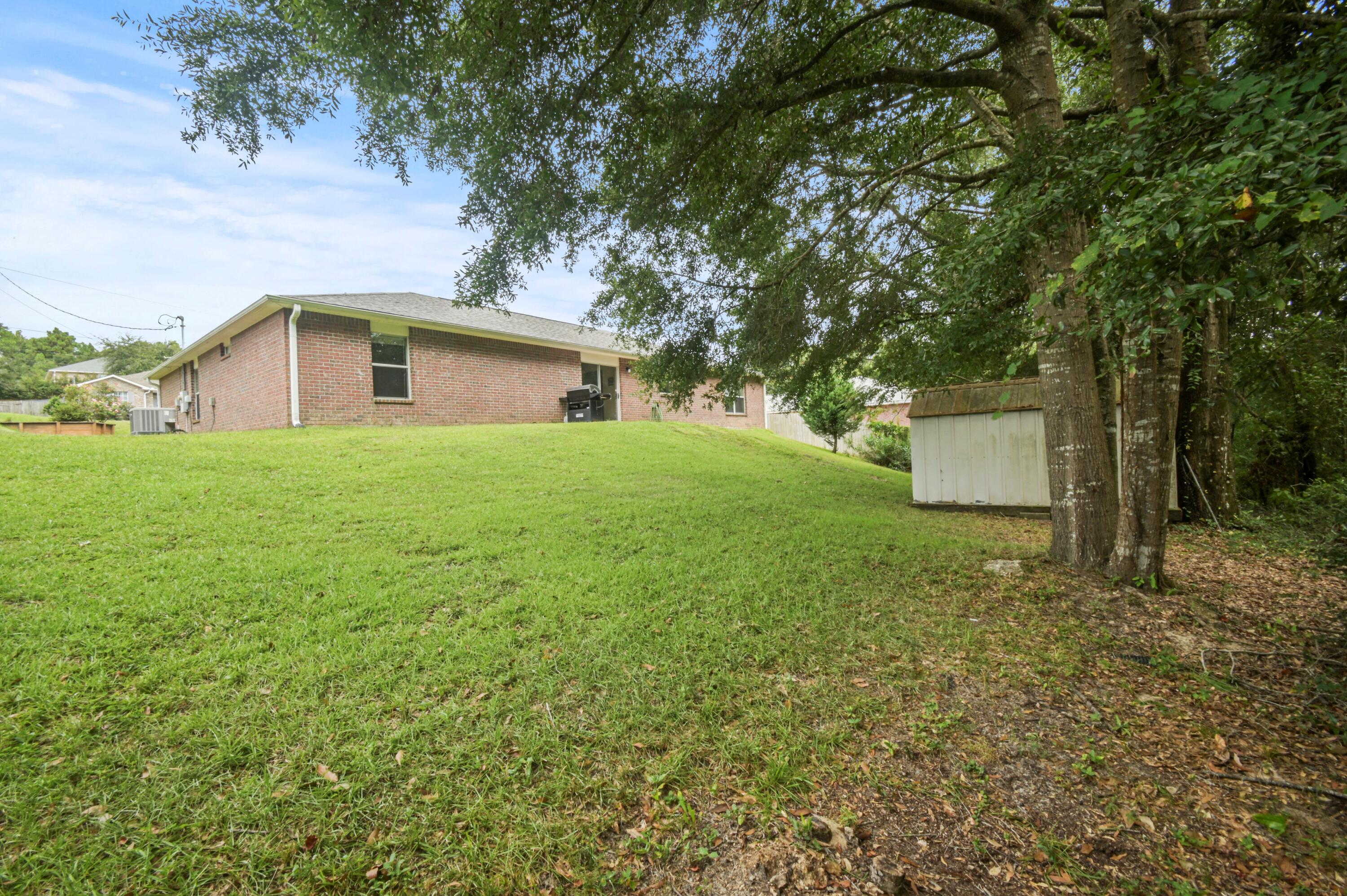 334 Egan Drive Crestview, FL 32536 - Photo 33 of 33 a front view of a house with a yard and a garage